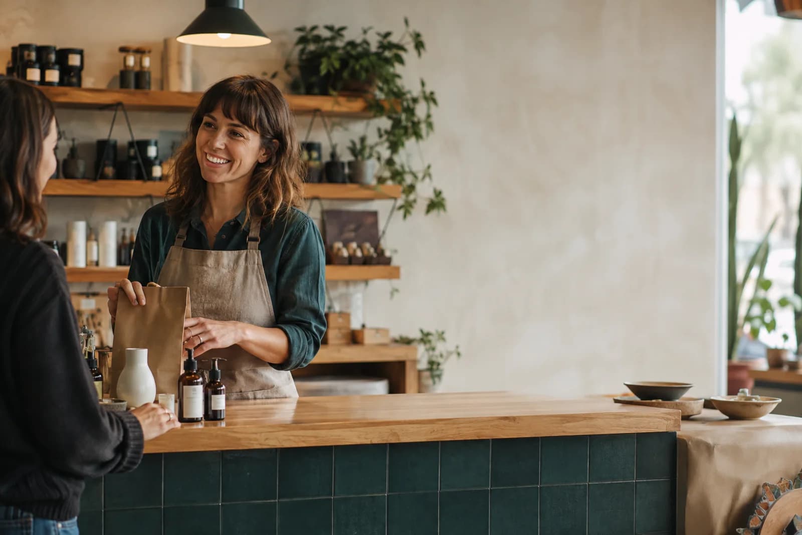 An independent shop owner helping a customer